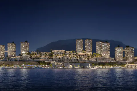 Night rendering of the illuminated tower skyline across the water